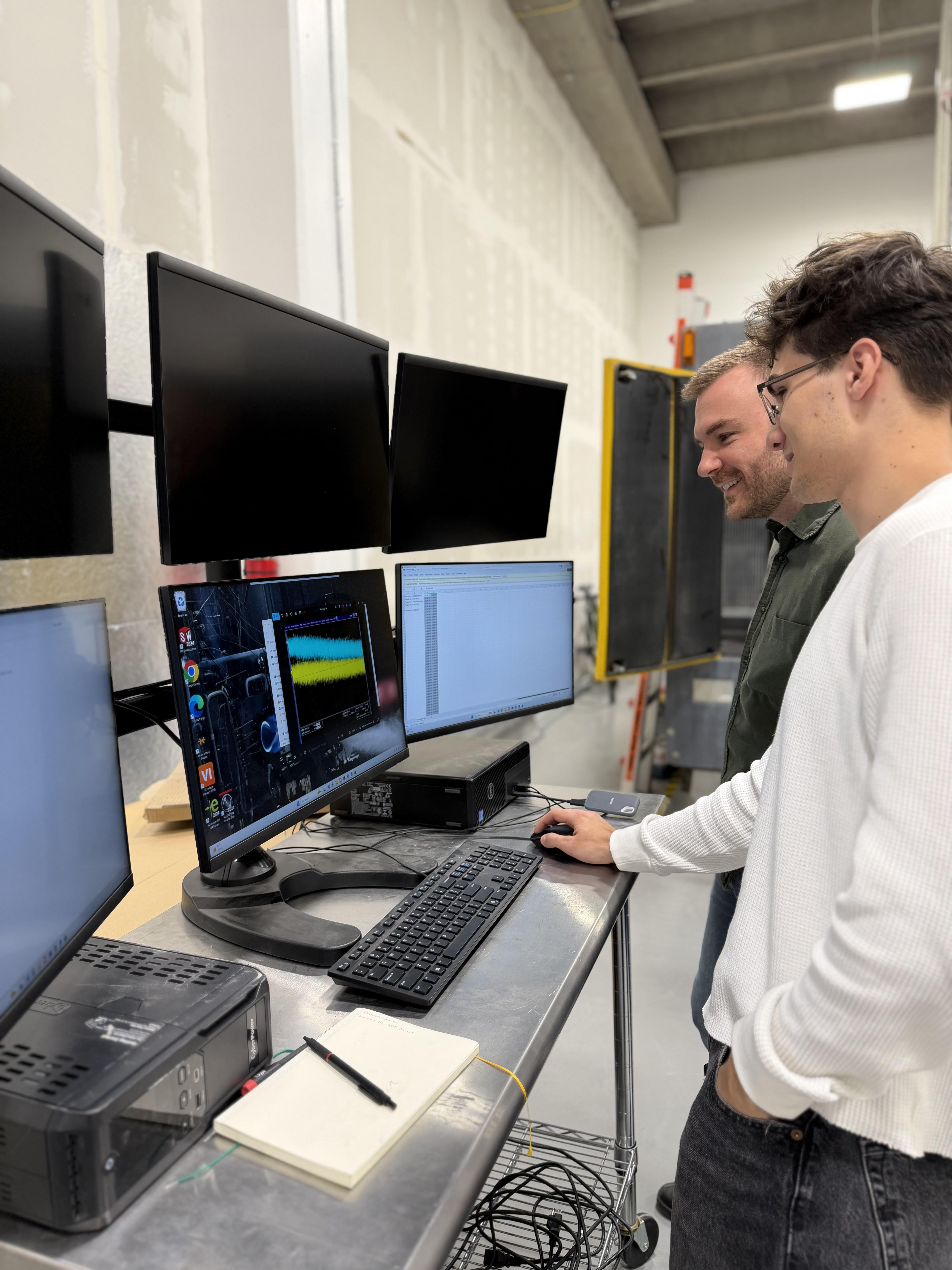 Students reviewing acquired data at the test stand